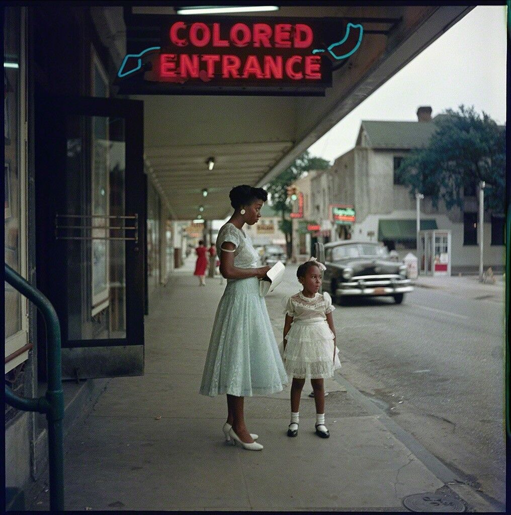 Black woman and child standing under a sign that reads "Colored Entrance." Photo taken in Alabama by: Gordon Parks